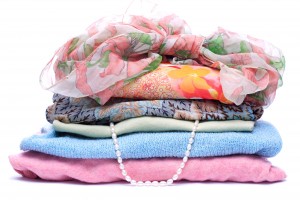 Stacks of women colored clothes on white background