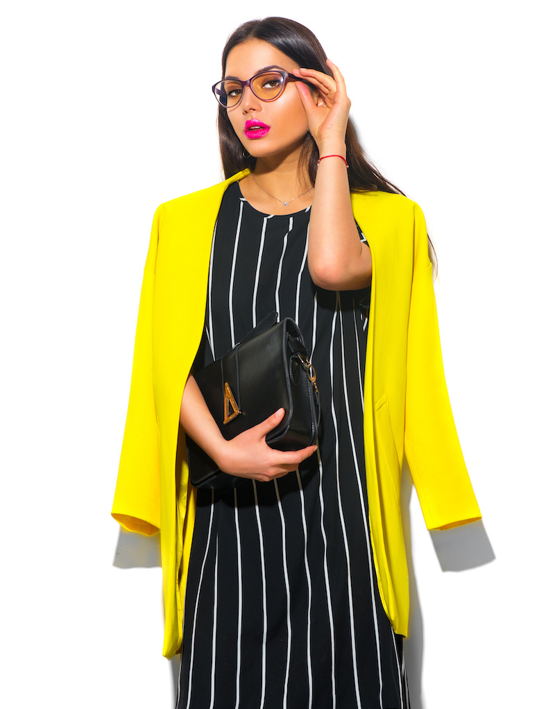 Stylish woman in yellow jacket and black dress