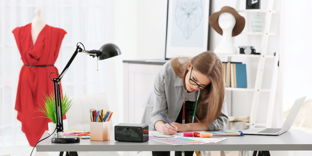Woman clothing designer working at a desk