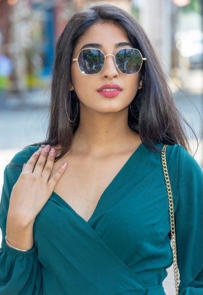 Pretty brunette in a blue-green dress.