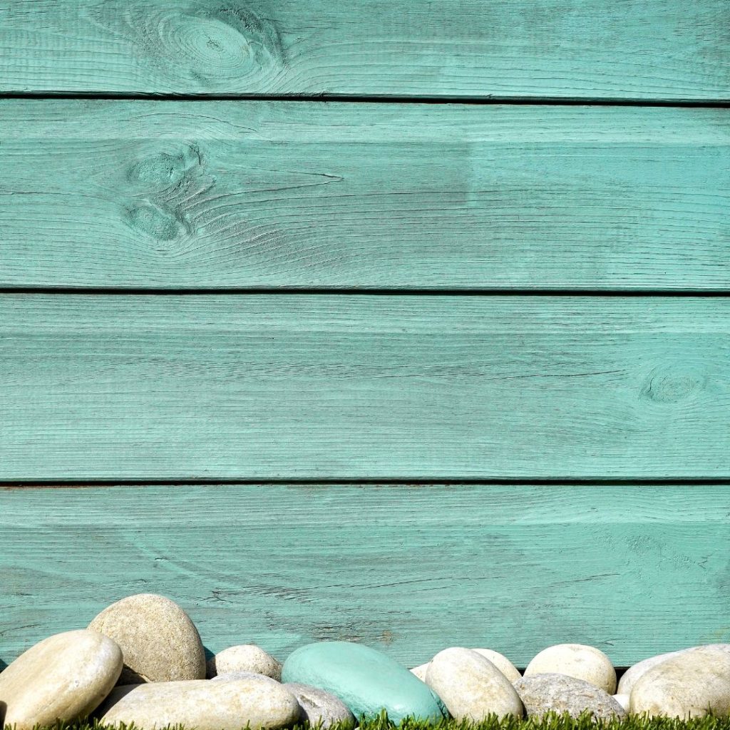Wood paneled exterior of a beach home in a turquoise color