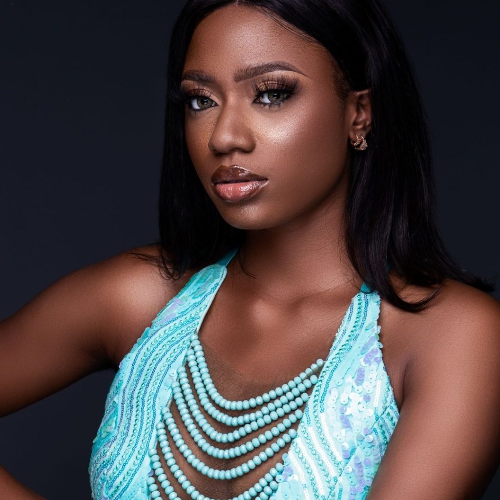 Beautiful African American woman wearing a teal halter top to show how color can enhance one's look.